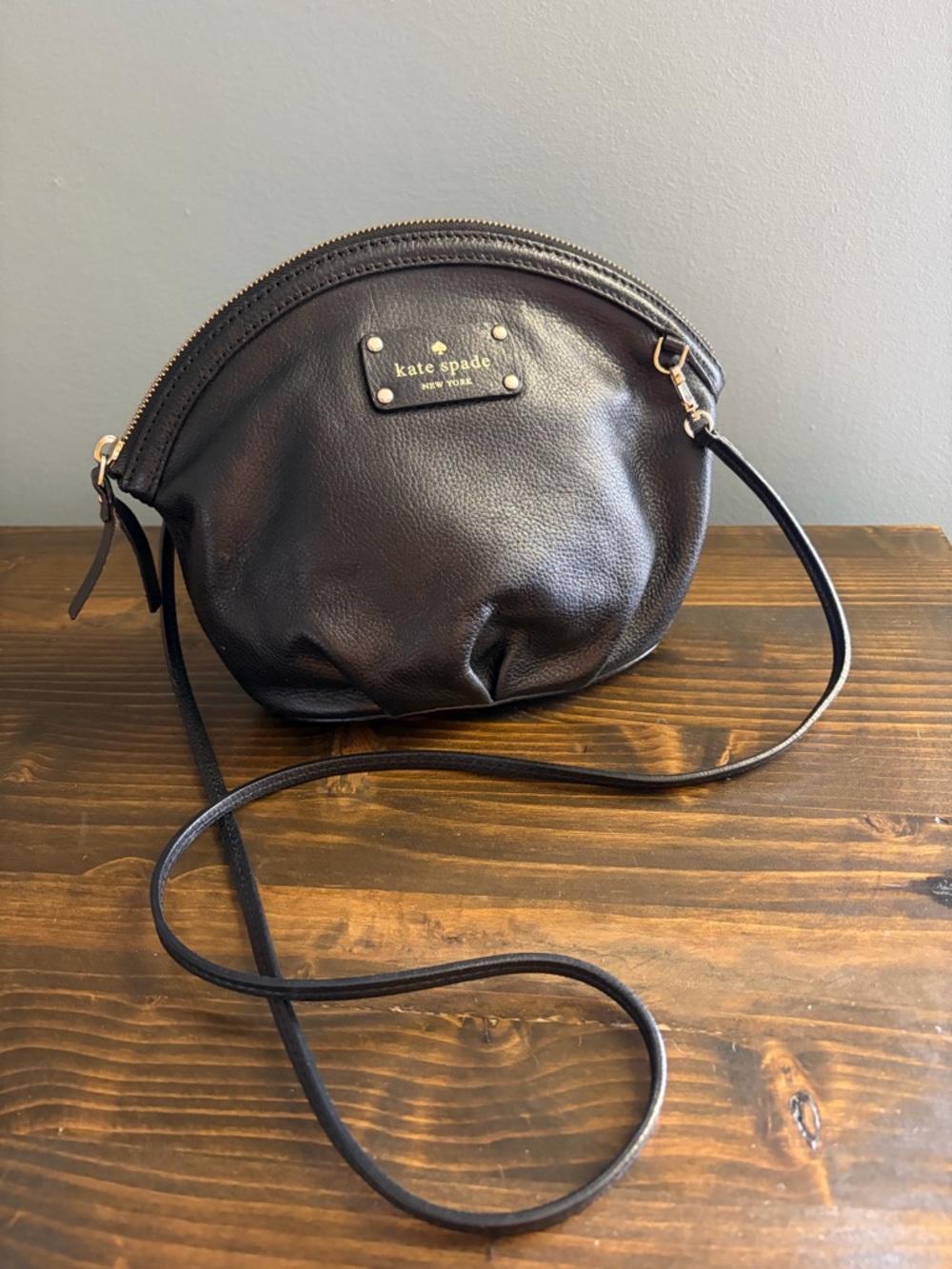 kate spade Black Pebbled Leather Rounded Top Crossbody with Gold Tone Logo